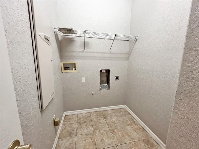 laundry room featuring electric dryer hookup, hookup for a washing machine, and light tile floors