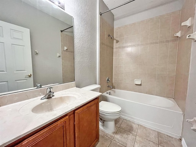 full bathroom featuring vanity, tile flooring, toilet, and tiled shower / bath