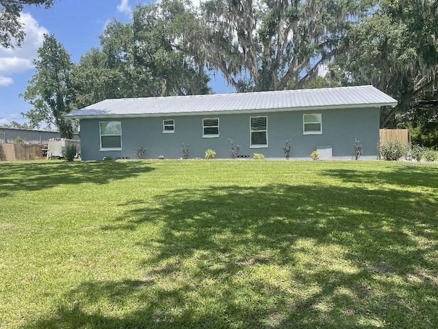 rear view of property with a yard