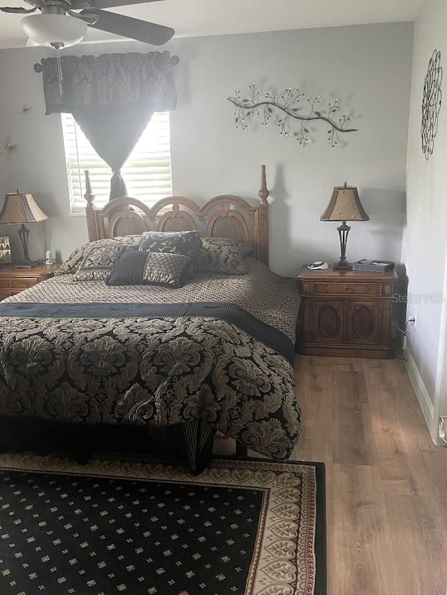 bedroom featuring ceiling fan and hardwood / wood-style flooring