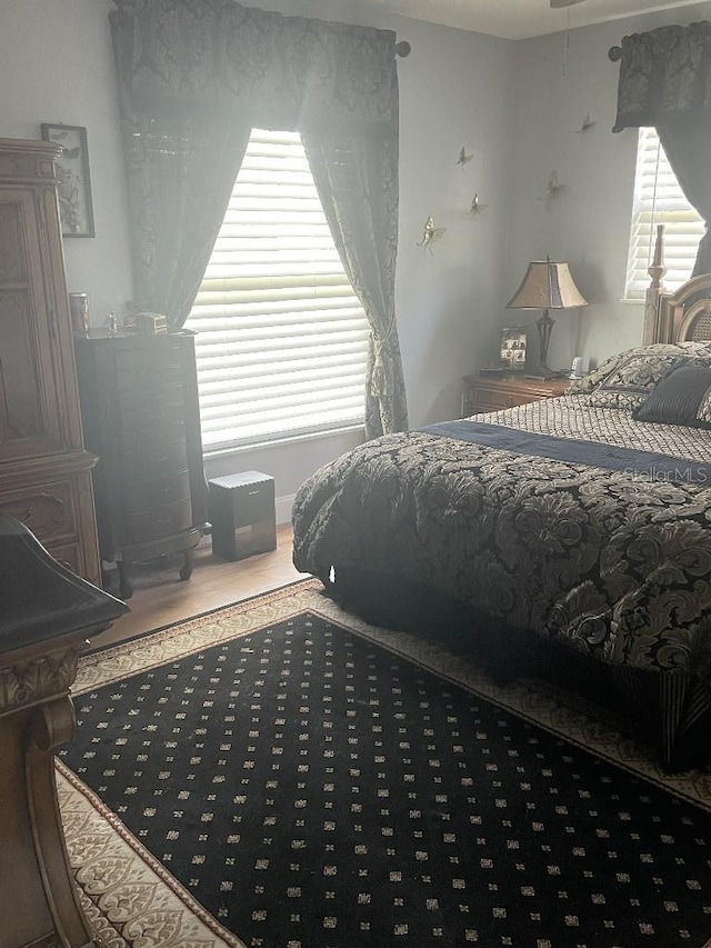 bedroom featuring hardwood / wood-style flooring and multiple windows