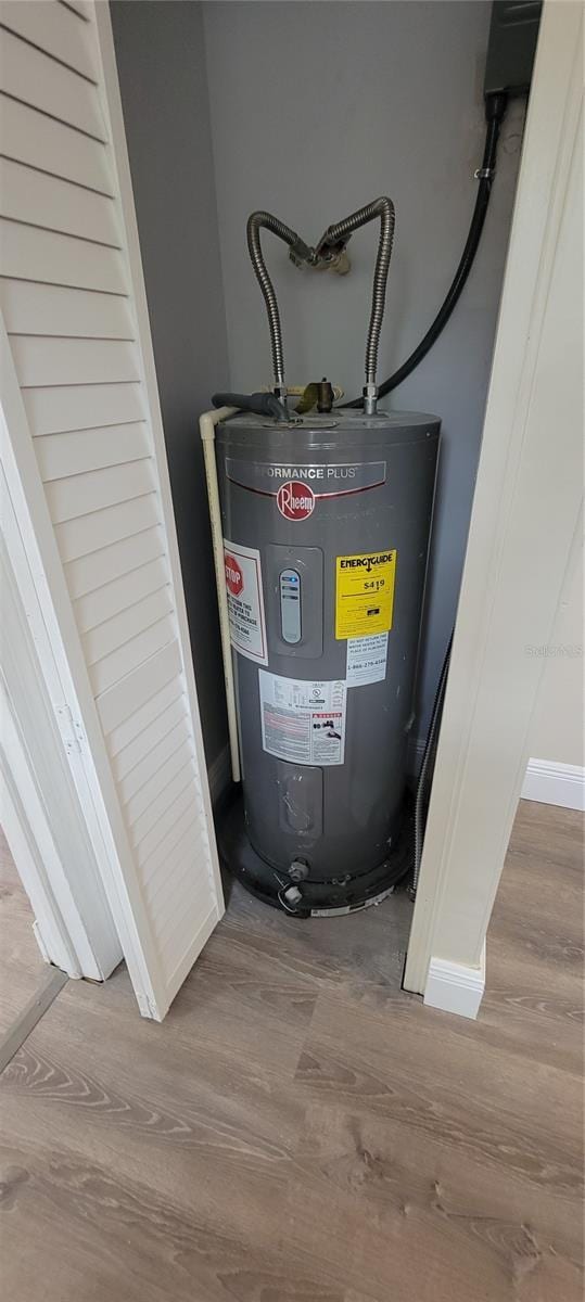 utility room featuring electric water heater