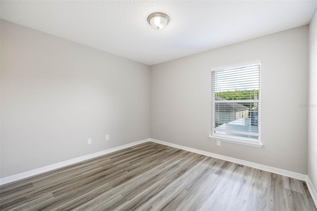 spare room with light hardwood / wood-style flooring