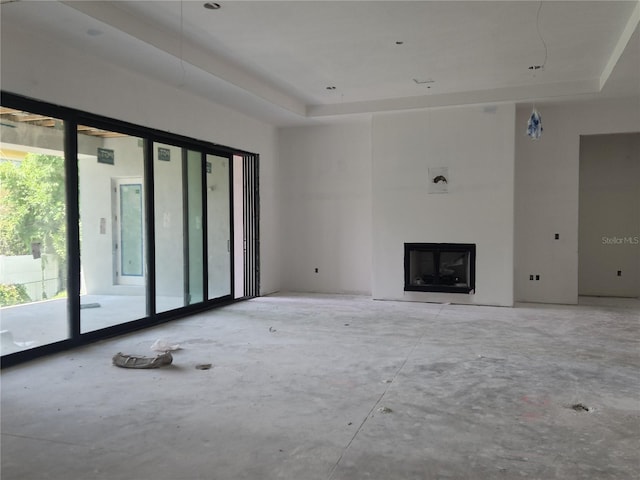 unfurnished living room featuring a tray ceiling