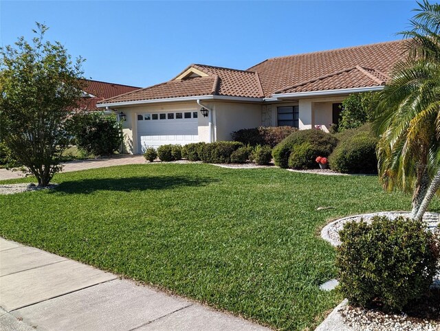 view of front facade featuring a front yard and a garage