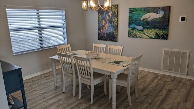 dining area featuring a chandelier and dark hardwood / wood-style flooring