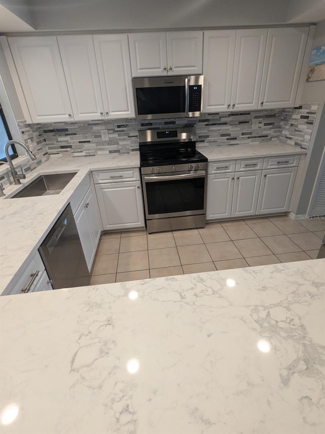 kitchen featuring white cabinetry, sink, and stainless steel appliances