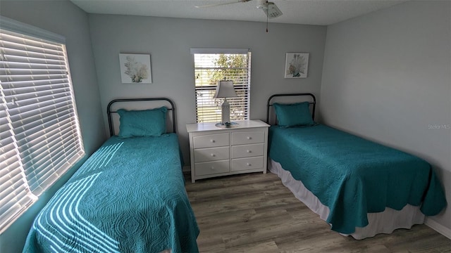 bedroom with ceiling fan, a textured ceiling, and hardwood / wood-style floors