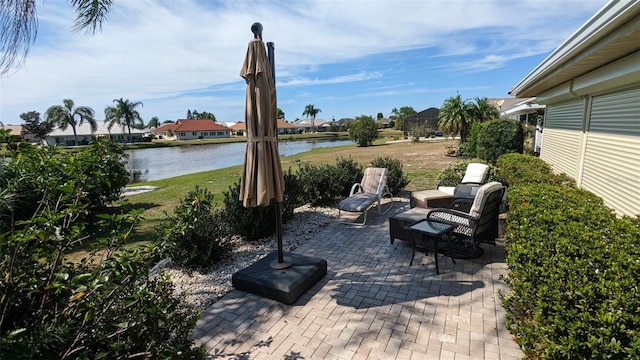 view of patio with a water view