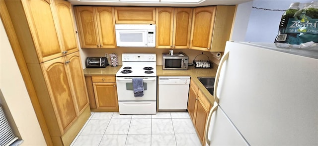 kitchen featuring white appliances and light tile floors