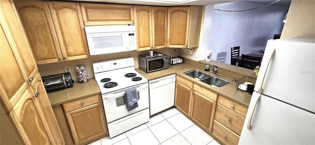 kitchen featuring sink, white appliances, and light tile floors