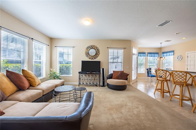 tiled living room with a wealth of natural light and a textured ceiling