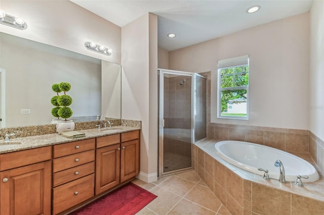 bathroom with separate shower and tub, oversized vanity, and double sink