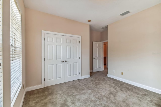 unfurnished bedroom featuring a closet and carpet floors