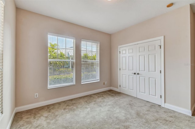 unfurnished bedroom featuring a closet and carpet floors