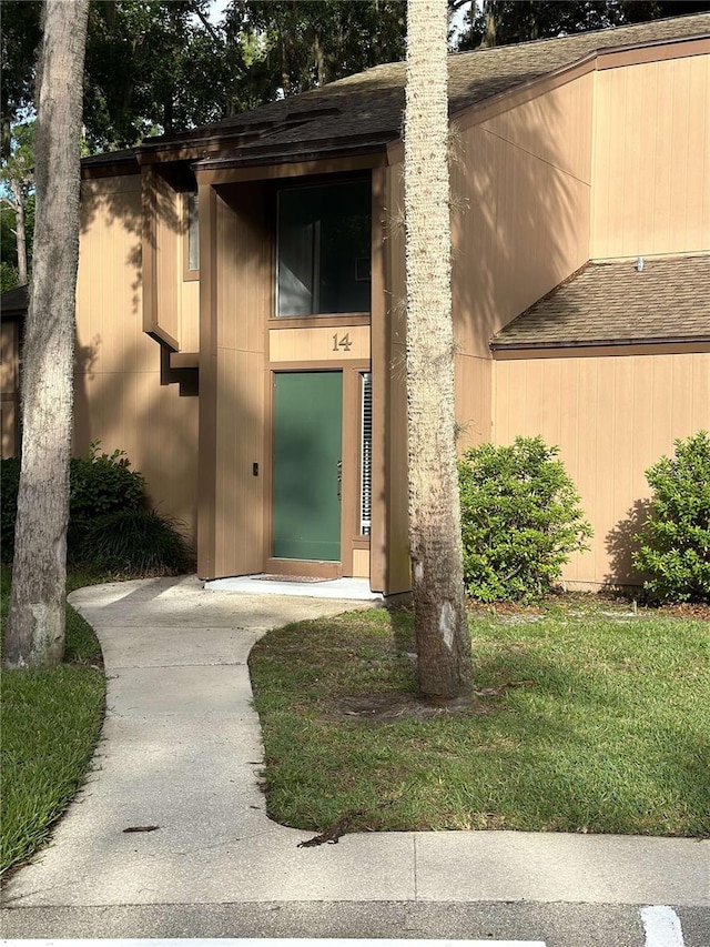 entrance to property featuring a lawn