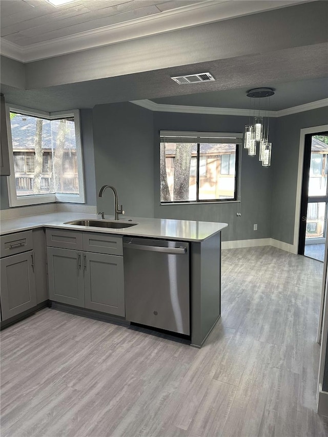 kitchen with sink, dishwasher, kitchen peninsula, hanging light fixtures, and light hardwood / wood-style flooring