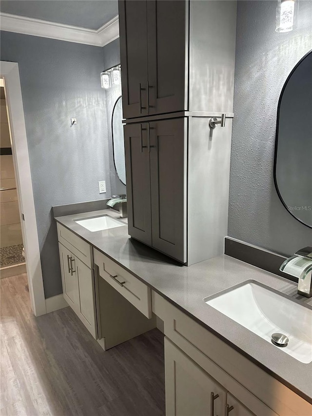 bathroom featuring vanity, hardwood / wood-style floors, crown molding, and walk in shower