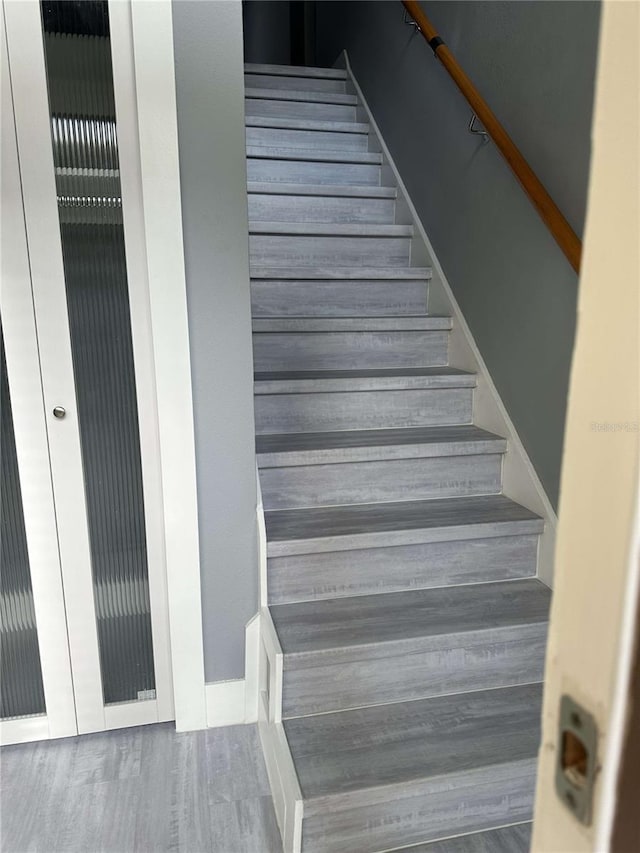 stairway with hardwood / wood-style floors