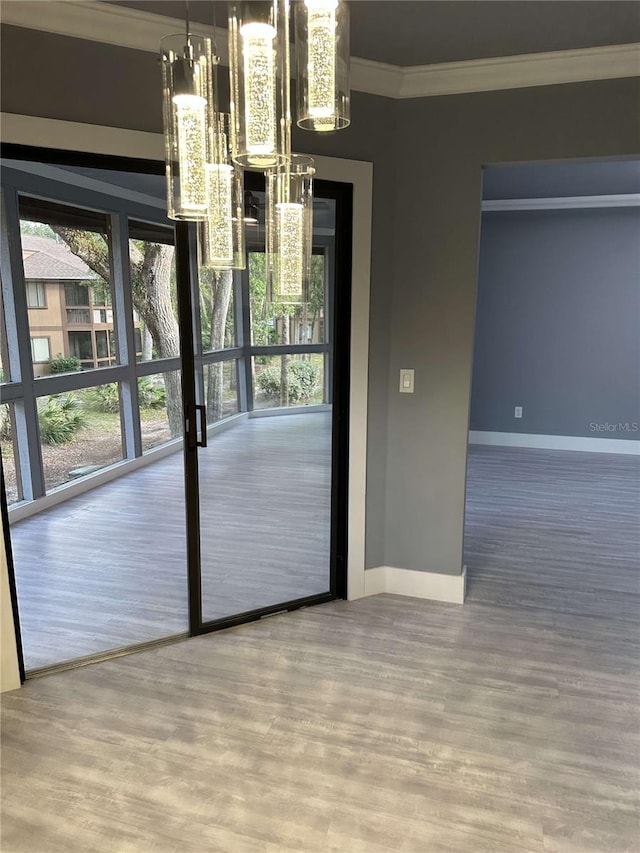 doorway to outside featuring ornamental molding and hardwood / wood-style flooring