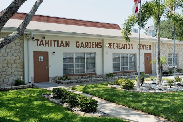 entrance to property with a lawn