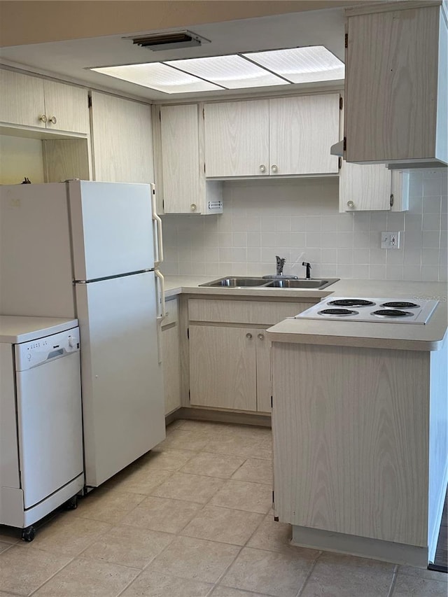 kitchen with backsplash, sink, white appliances, and light tile floors