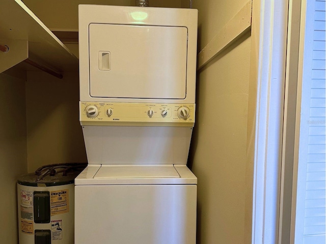 clothes washing area with stacked washer and dryer and electric water heater