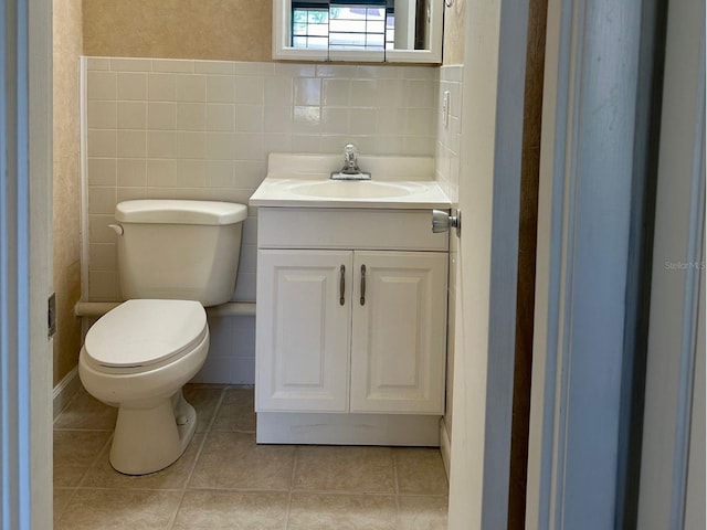 bathroom with tile flooring, tile walls, tasteful backsplash, toilet, and vanity