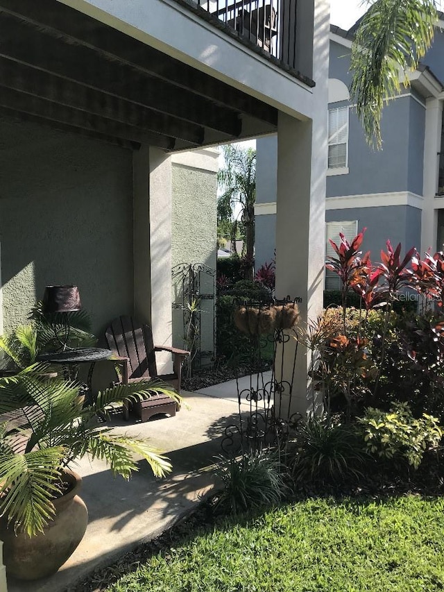 view of yard featuring a balcony and a patio