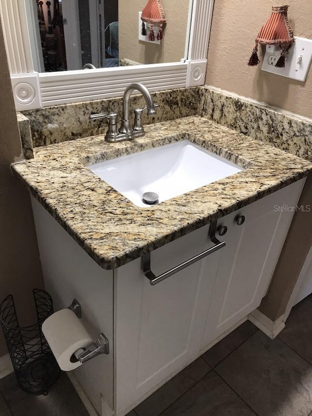 bathroom featuring tile flooring and oversized vanity