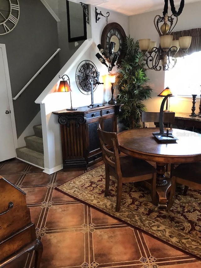 dining area featuring dark tile flooring