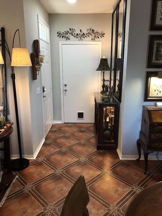 entryway featuring dark tile floors