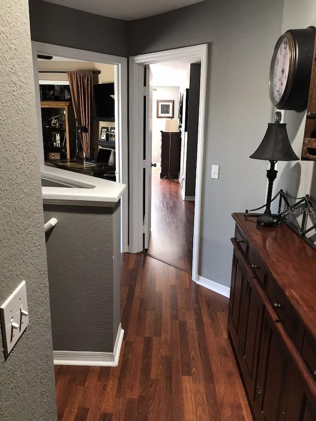 hall with dark wood-type flooring