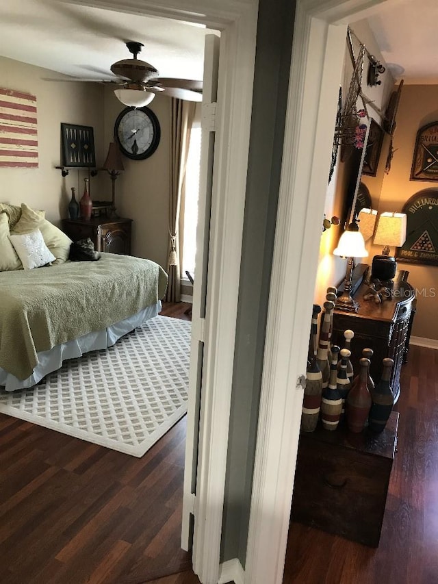 bedroom featuring ceiling fan and dark wood-type flooring