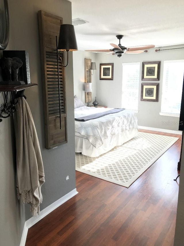 bedroom featuring ceiling fan and dark wood-type flooring