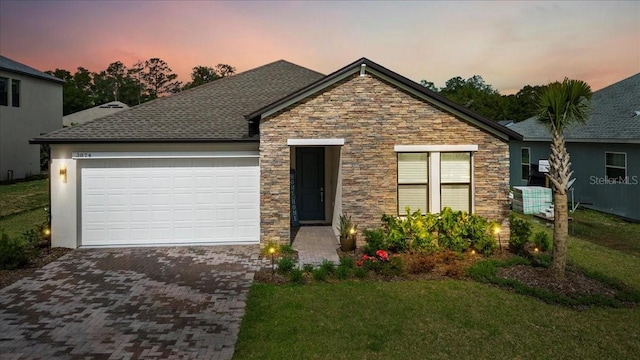 view of front of home featuring a yard and a garage