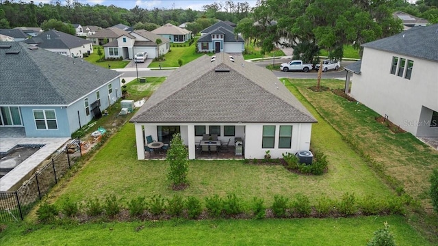 rear view of property featuring a lawn, a patio, and central AC