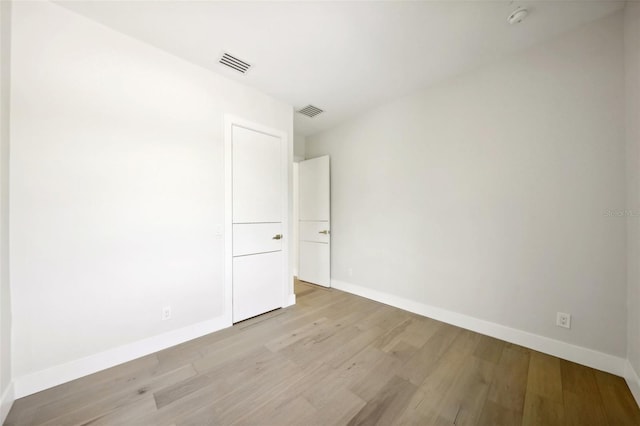 unfurnished room with light wood-type flooring