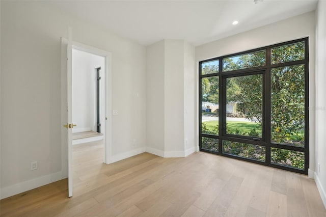 unfurnished room with light hardwood / wood-style floors