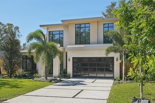 view of front facade with a front yard and a garage