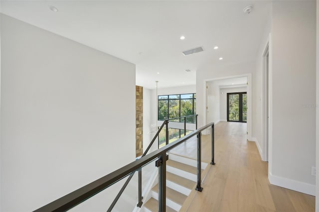 hallway with light hardwood / wood-style flooring