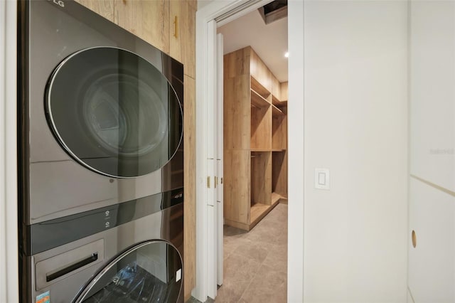 laundry room with stacked washing maching and dryer