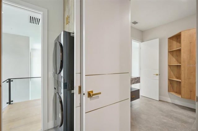 laundry room featuring stacked washing maching and dryer