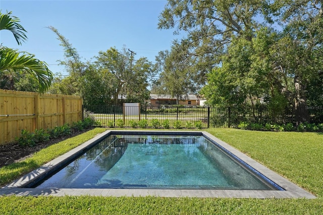 view of swimming pool with a yard