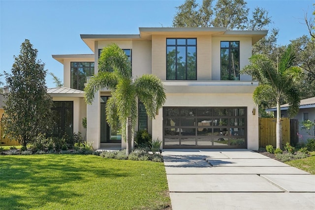 view of front of property with a garage and a front yard