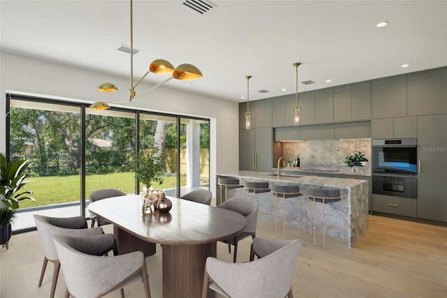 dining area featuring light hardwood / wood-style floors and sink