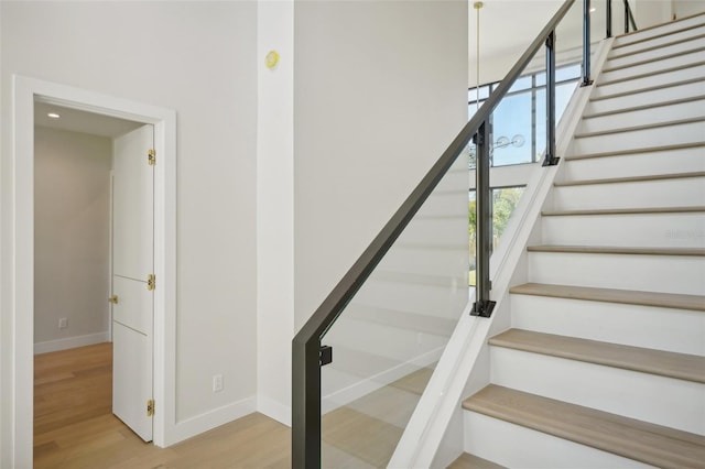 staircase with hardwood / wood-style floors