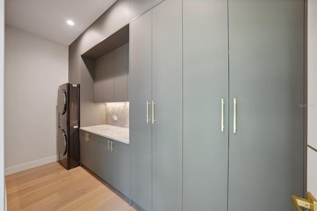 closet with stacked washer and clothes dryer