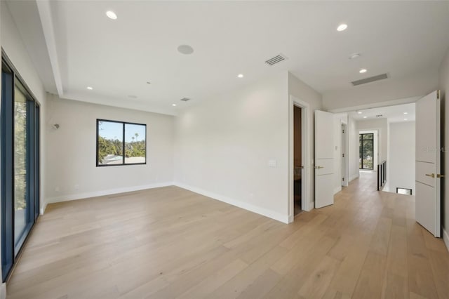 spare room with light hardwood / wood-style flooring