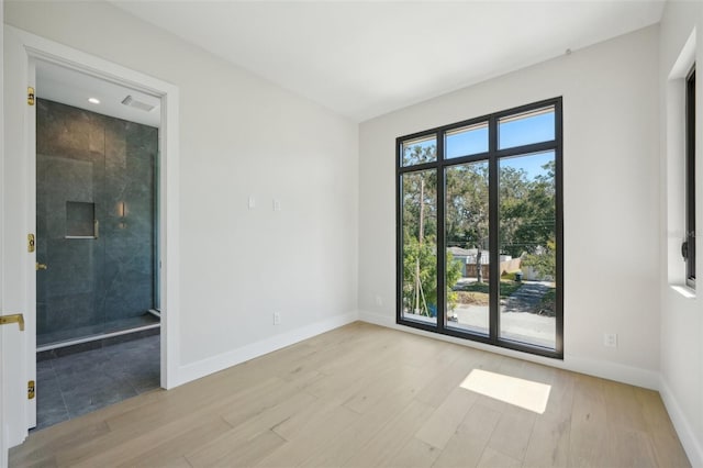 unfurnished room with light wood-type flooring